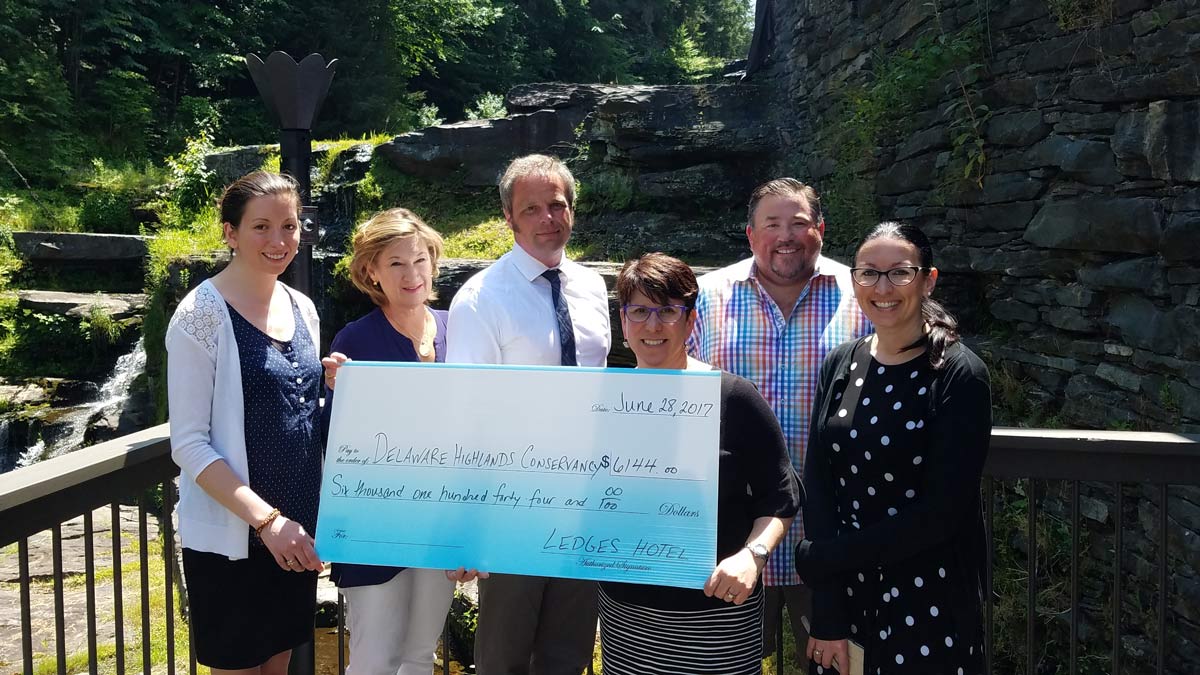 Ledges Hotel presents the Conservancy with a check.