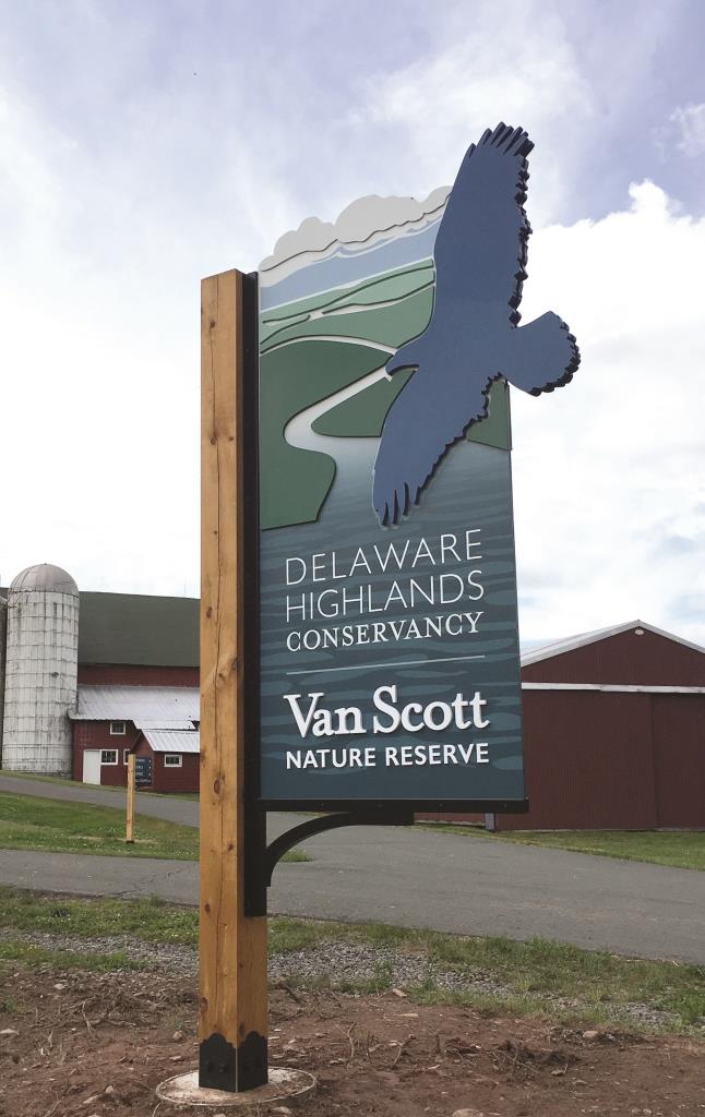 The sign at the Reserve entrance that reads Delaware Highlands Conservancy Van Scott Nature Reserve.