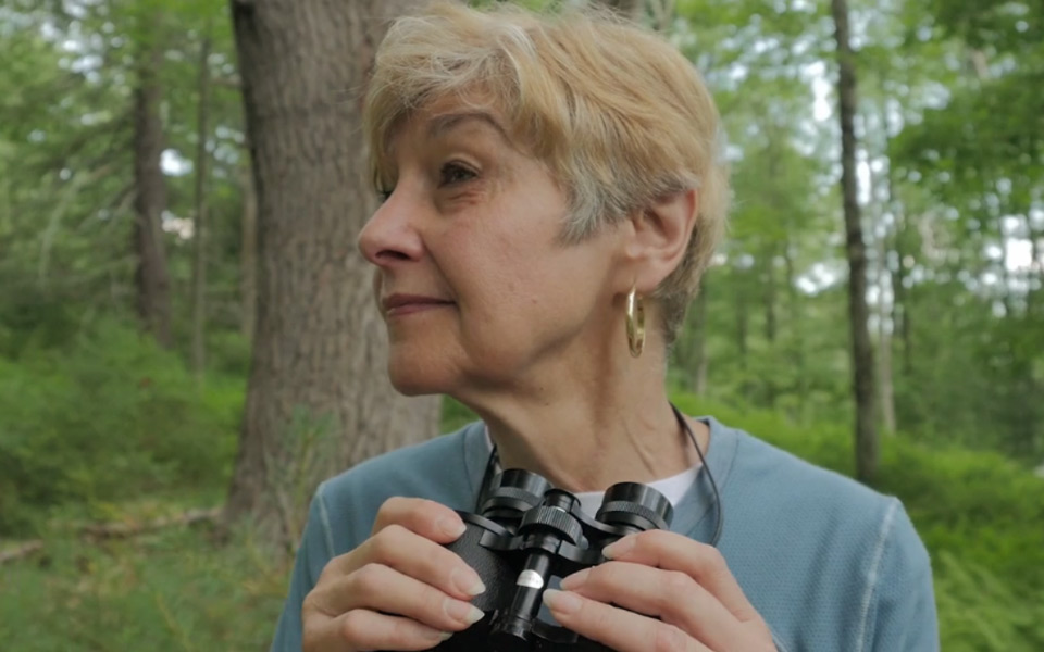 Christine Foland with binoculars